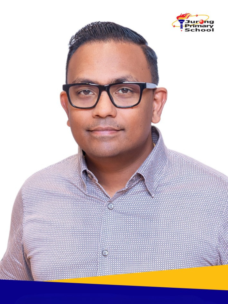 Smiling man in patterned grey shirt, black rectangular glasses
